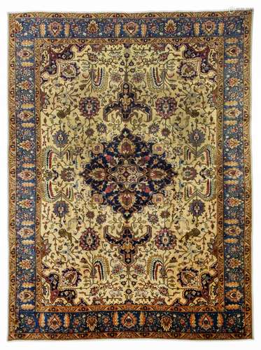 A TABRIZ CARPET, NORTH-WEST PERSIA approx: 12ft.5in. x 9ft.2in.(379cm. x 279cm.) The sandy-beige field with polychrome palmettes, leafy sprays and angular floral vine around indigo with similar motifs. In light blue border of polychrome palmettes and delicate floral vine between apricot angular floral meander and plain stripes. touches of tiny wear to the top pile, otherwise good. in general this carpet is in very good usable condition. Selvages rebound. Ends with short fringes, secured. Very good furnishing piece. Attractive. Ca.1920