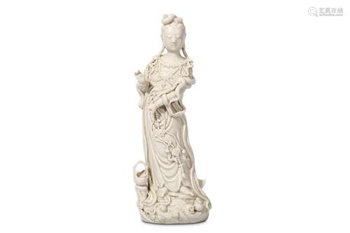 A CHINESE BLANC DE CHINE FIGURE OF GUANYIN. Late Qing Dynasty. Standing in flowing robes with a