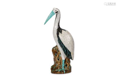 A CHINESE EXPORT FIGURE OF A CRANE. 19th Century. Standing on a rocky base, the head slightly