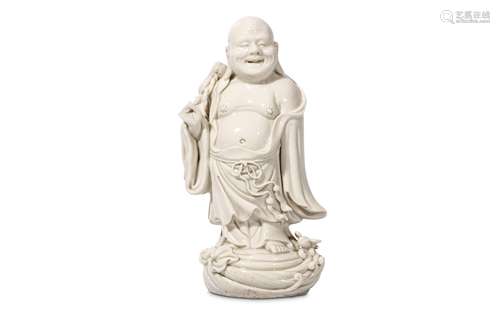 A CHINESE BLANC DE CHINE FIGURE OF BUDDHA. Late Qing Dynasty. Standing in flowing robes, the chest