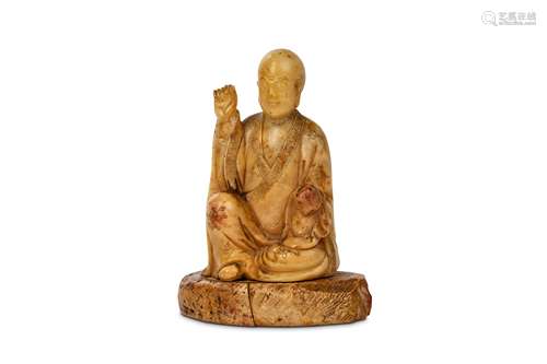 A CHINESE SOAPSTONE CARVING OF LOHAN. Qing Dynasty. Seated in long flowing robes the right arm