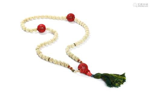 A PIERCED IVORY NECKLACE. 19th Century. Comprised of pierced and hollow circular ivory beads, some