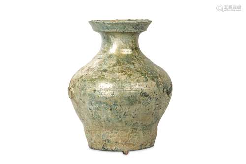 A CHINESE GREEN-GLAZED VASE, HU. Han Dynasty. The body and shoulder encircled by triple bow-string