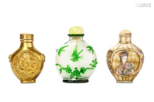 THREE CHINESE SNUFF BOTTLES AND STOPPERS. 19th / 20th Century. Comprising a gild metal bottle with