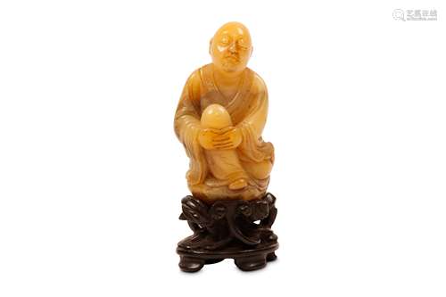 A CHINESE SEATED SOAPSTONE FIGURE. Qing Dynasty, or later. Seated with the eyes downcast in