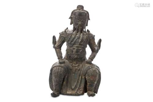 A CHINESE BRONZE FIGURE OF GUANDI. Ming Dynasty. Seated in full armour the legs wide and hands