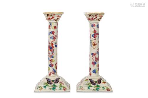 A PAIR OF CHINESE CANTON FAMILLE ROSE CANDLE STICKS. Qing Dynasty, Jiaqing era. The cylindrical