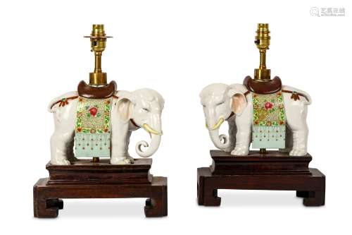 A PAIR OF CHINESE FAMILLE ROSE ‘ELEPHANT’ CANDLE STICKS. Qing Dynasty. Each standing four-square in