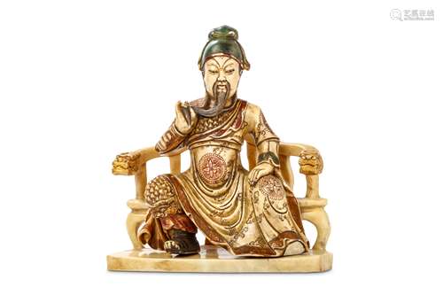 A CHINESE SOAPSTONE CARVING OF A FIGURE. Seated in long flowing robes, the legs spread, the left