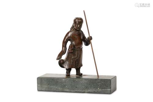 A BRONZE STANDING FIGURE. Ming Dynasty. Standing in long flowing robes, a staff held in the left