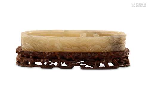 A CHINESE JADE WASHER. Qing Dynasty. The thick walled shallow oval washer incised to the sides and