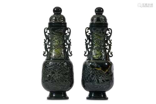 A PAIR OF CHINSE SPINACH JADE VASES AND COVERS. 20th Century. Of elongated form the compressed