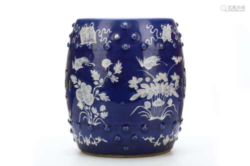 A CHINESE BLUE-GROUND WHITE-SLIP DECORATED DRUM STOOL. Qing Dynasty. Of barrel form with two rows