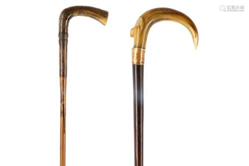 TWO WALKING STICKS WITH RHINOCEROS HORN HANDLES. Circa 1920. 85cm, 93cm. 約一九二零年   鑲犀角拐杖兩隻
