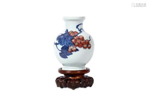 A CHINESE BLUE AND WHITE AND COPPER RED VASE. 20th Century. The globular body on a stepped splayed