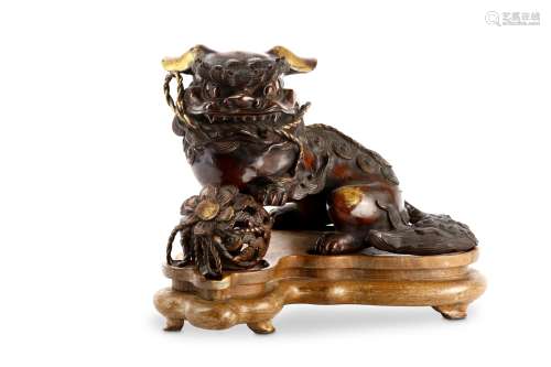 A JAPANESE BRONZE MODEL OF A LION DOG AND A BALL. 19th Century. A shishi dog seated with his front