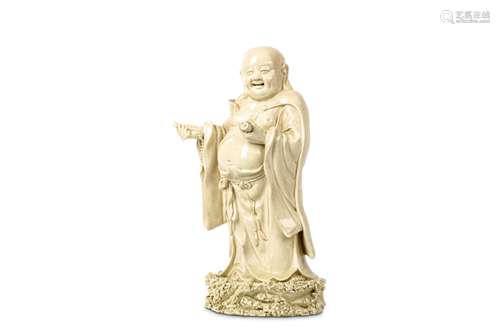 A CHINESE BLANC DE CHINE FIGURE OF BUDDHA. Late Qing Dynasty. Standing on a rocky base in long