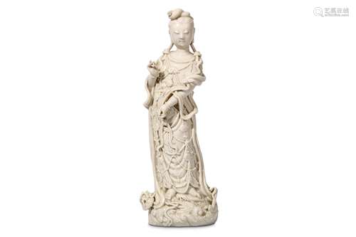 A CHINESE BLANC DE CHINE FIGURE OF GUANYIN. Late Qing Dynasty. Standing in flowing robes, a ruyi