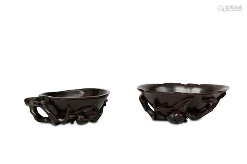 TWO CHINESE HARDWOOD LIBATION CUPS. Qing Dynasty. One carved as a peach fruit with attendant branch,