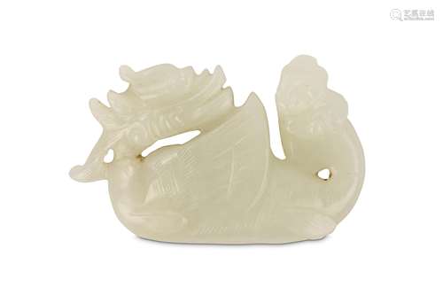 A CHINESE JADE ‘DRAGON FISH’ CARVING. 19th / 20th Century. Seated with the head turned back over