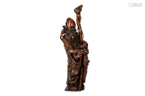 A CHINESE LARGE ROOT CARVING OF SHOU LAO. 19th / early 20th Century. Standing in flowing robes, the