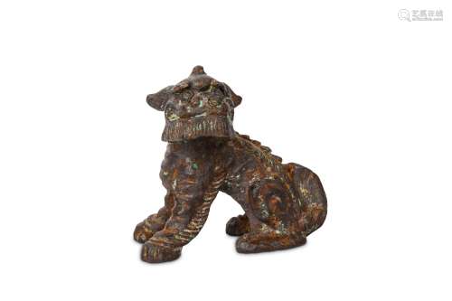 A CHINESE IRON BUDDHIST LION DOG. Ming Dynasty. Seated with the head raised and turned to the