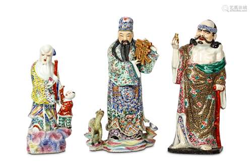 THREE CHINESE FAMILLE ROSE FIGURES. 20th Century. Each standing wearing brightly enamelled clothes,