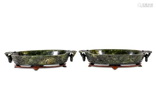 A PAIR OF CHINESE SPINACH JADE WASHERS. Late Qing Dynasty. Each incised to the exterior with