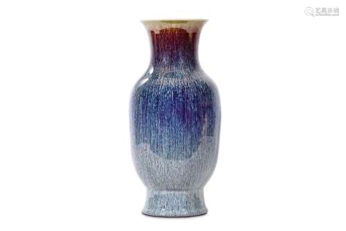 A CHINESE FLAMBÉ GLAZED VASE. Qing Dynasty. Of baluster form with a flared neck raised on a