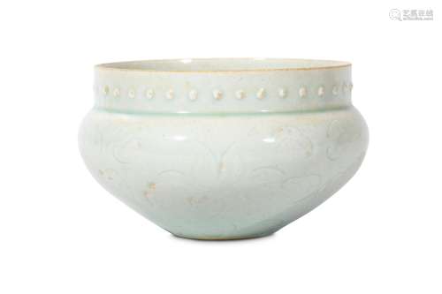 A CHINESE QINGBAI BOWL. The rounded body incised with floral patterns and shoulders surmounted by a