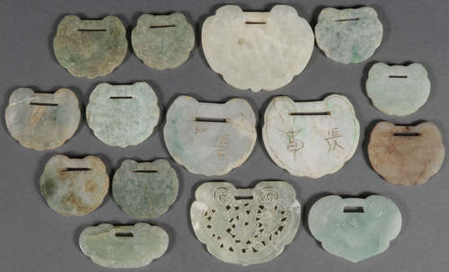 A GROUP OF 15 CHINESE CARVED JADE PENDANTS