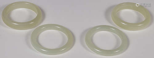 EIGHT CHINESE CARVED JADE BANGLES