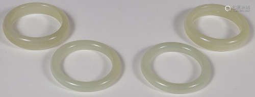 EIGHT CHINESE CARVED JADE BANGLES