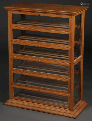 A FINE A.N. RUSSELL & SONS OAK RIBBON CABINET