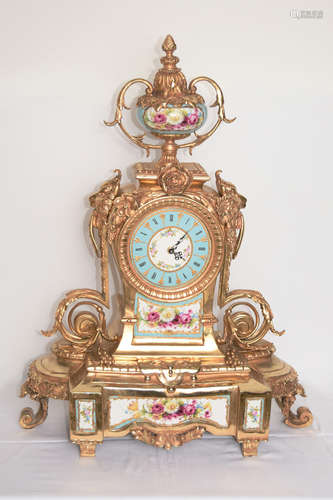 A 74cm Large Continental Gilt Bronze Clock with Lion Heads and Porcelain Surface