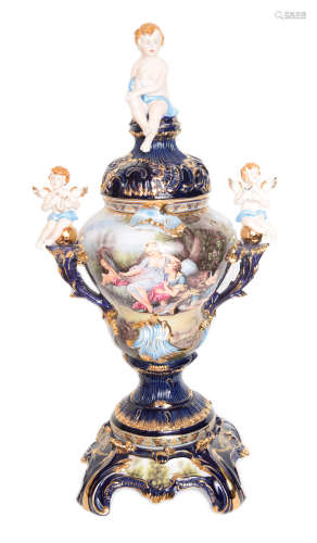 A 92cm Large Continental Indigo Ground Porcelain Lidded Urn with Three Cherubs