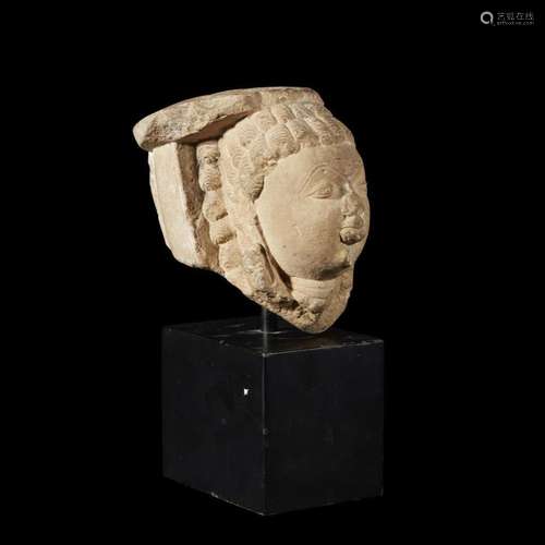 An Indian carved buff sandstone head, 11th/12th century