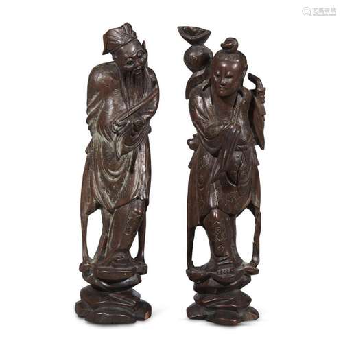 Two Chinese carved wood and silver wire-inlaid figures of Daoist immortals, qing dynasty