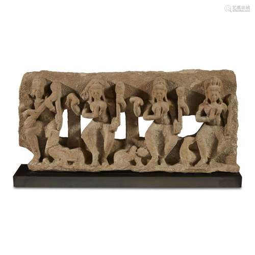 An Indian carved and pierced stone frieze panel depicting four of the 