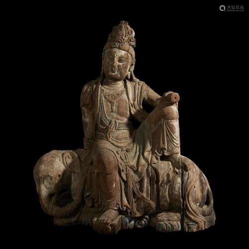 A large Chinese carved wood figure of Samantabhadra, seated on an elephant, ming dynasty or earlier