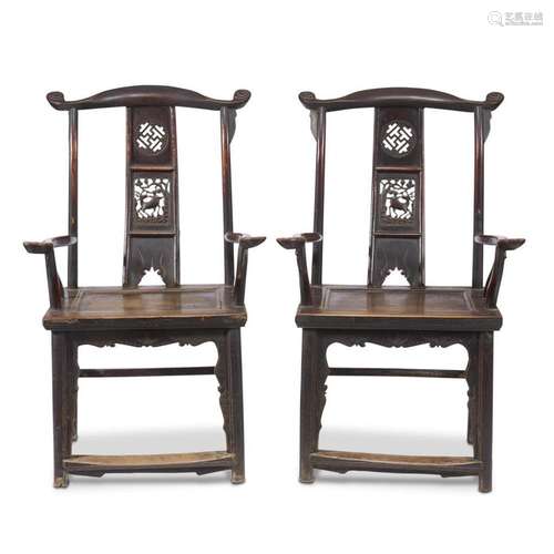 A pair of Chinese lacquered and carved wood yoke-backed armchairs,