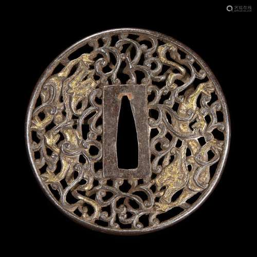 A Japanese parcel-gilt pierced iron tsuba decorated with dragons among scrollwork, edo period, 18th century or earlier