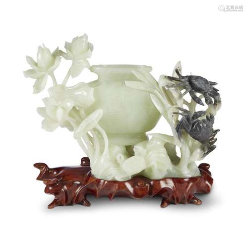 A Chinese carved grey and celadon jade group depicting a basket, lotus, and crabs,