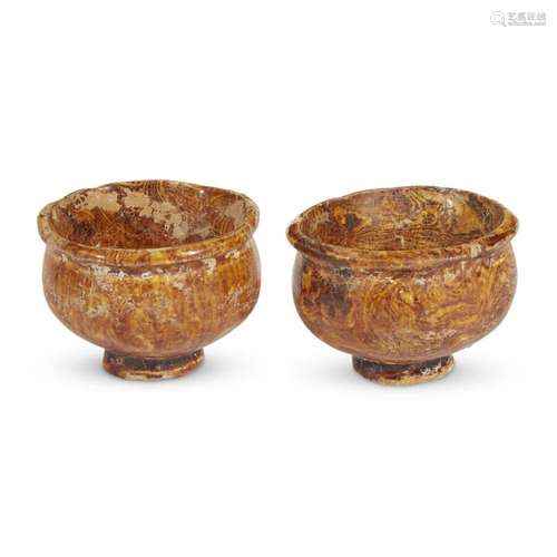 A pair of Chinese amber-glazed marbled pottery wine cups, tang dynasty