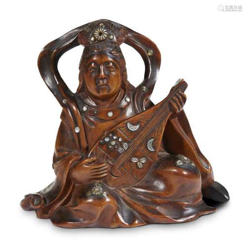 A Japanese carved and inlaid boxwood okimono depicting a seated bodhisattva with biwa, signed Komin, meiji period, 19th century