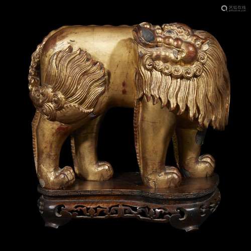 A Chinese gilt-lacquered carved wood Buddhist lion, qing dynasty, 19th century