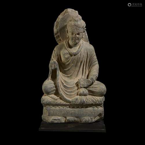 A Gandhara carved and inscribed schist figure of the seated Buddha, 3rd to 5th century