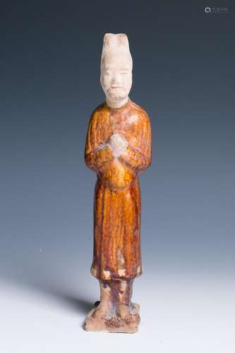 A POTTERY FIGURE OF A STANDING ATTENDANT, TANG