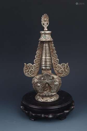 A FINELY CARVED AND TALL SILVER PLATED STUPA