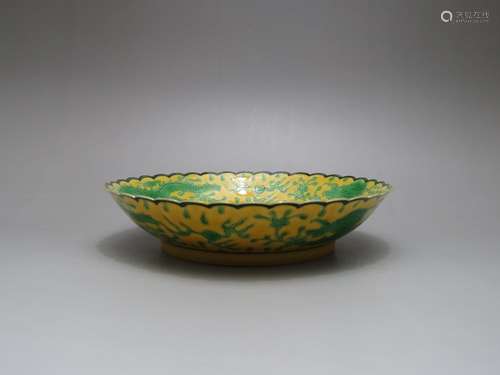 A YELLOW-GROUND, GREEN-ENAMELED DISH, QIANLONG MARK